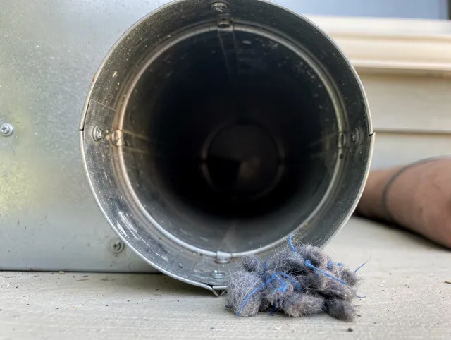 West Haven Dryer Vent Cleaning technician using specialized equipment to clear severe dryer vent blockage in West Haven